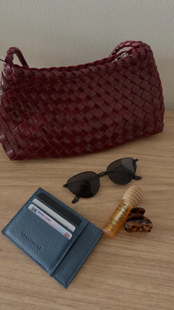 Portmonee, Karten und Sonnenbrille auf einem Tisch